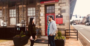 History buffs and Gone with the Wind enthusiasts, Viranch Trivedi and Hui Wang, standing in front of The Road to Tara Museum